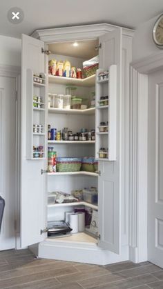 an open pantry in the corner of a room with a dining table and chairs next to it