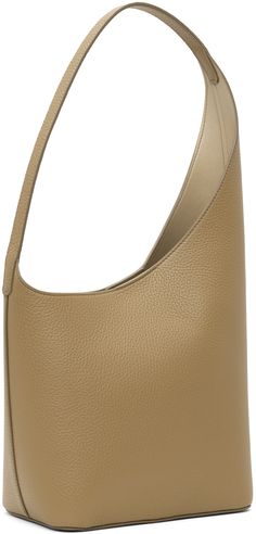 Grained calfskin shoulder bag in taupe. · Integrated shoulder strap · Logo embossed at face · Magnetic closure at asymmetric throat · Patch pocket at interior · Buffed faux-leather lining · H14 x W9.5 x D4 · Total height: H16 Supplier color: Grain terra Taupe Leather Shoulder Bag With Smooth Grain, Taupe Textured Leather Shoulder Bag For Office, Luxury Beige Hobo Bag With Smooth Grain, Beige Calf Leather Shoulder Bag With Smooth Grain, Modern Beige Textured Leather Shoulder Bag, Magnetic Closure, Patch Pocket, Calf Skin, Shoulder Strap