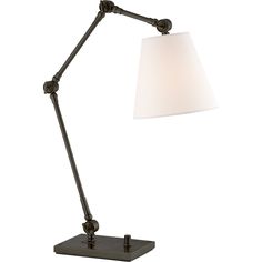 a desk lamp with a white shade on the base and a black metal frame around it