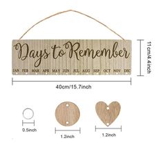 a wooden sign with the words days to remember on it and two heart shaped tags hanging from