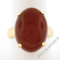 --Stone(s):-- (1) Natural Genuine Carnelian - Oval Cabochon Cut - Prong Set - Rich Reddish Orange Color - 20.5x15.2mm (approx.) Material: 18K Solid Yellow Gold Weight: 10.6 Grams Ring Size: 9.5 (Fitted on a finger. We can custom size this ring - please contact us prior to purchase for sizing inquiries) Ring Width: 20.5mm (0.80") (top of the ring - north to south- at the stone), 3.4mm (bottom of the shank) Ring Height: 13.7mm rise off the finger Condition: Excellent condition! Stock Number: MK-11 Carnelian Oval Jewelry For Anniversary, Formal Jewelry With Oval Cabochon Natural Stones, Oval Carnelian Jewelry For Anniversary, Formal Oval Cabochon Natural Stone Jewelry, Oval Carnelian Yellow Gold Jewelry, Formal Oval Cabochon Carnelian Jewelry, Oval Gemstones In 14k Gold With Polished Finish, Classic Oval Carnelian Jewelry, Oval Carnelian Jewelry With Polished Finish