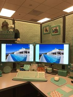 two computer monitors sitting on top of a desk in front of a keyboard and mouse