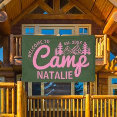 the welcome sign to camp natale is hanging from the front of a log cabin