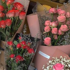 several bouquets of roses are on display for sale