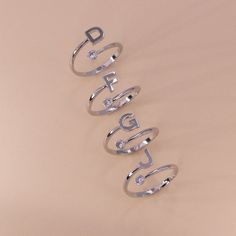 Mix and match our adjustable monogram cuff ring with other rings in your collection or wear it alone. One end of the ring ends with the monogram, while the other ends in a single cubic zirconia stone that adds sparkle. Adjust for a comfortable fit. Adjustable Size: (FITS SIZE 5, 6, 7, OR 8) Stone: Cubic Zirconia Material: Brass Letter Size: 6x6 mm Ring Thickness: 1.5 mm Adjustable White Gold Initial Open Ring, Adjustable Initial Diamond Ring, Adjustable Diamond Initial Ring, Trendy Adjustable Initial Open Ring, Trendy Silver Initial Open Ring, Adjustable Monogram Initial Ring In White Gold, Adjustable Monogrammed Initial Ring In White Gold, Monogrammed White Gold Initial Ring, Adjustable Monogram Open Ring Jewelry