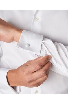 Modern French cuffs add elegance to a spread-collar dress shirt richly woven from pure cotton. Since 1928, Eton has been making men’s shirts that meet the highest expectations of quality, fusing Scandinavian sensibilities and the rich traditions of English textiles. They make a shirt that is well worth wearing, and because they take ownership of the production process from day one, the quality never wavers. Permanent collar stays. French placket. Curved hem. Back yoke. 100% cotton. Machine wash Affordable White Men's Dress Shirt, Cheap White Men's Dress Shirt, Timeless Long Sleeve Dress Shirt With Button Cuffs, Classic Collared Shirt With Cuffed Sleeves, Classic Long Sleeve Dress Shirt With Covered Buttons, Elegant Long Sleeve Dress Shirt With Button Cuffs, Classic Collared Dress Shirt With Covered Buttons, Elegant Shirt With Covered Buttons And Fold Down Collar, Elegant Fitted Shirt With Covered Buttons