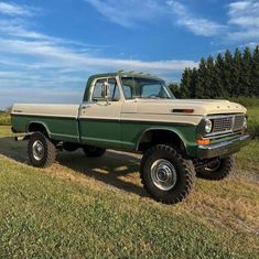 an old pick up truck parked in a field