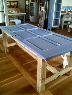 a blue table sitting on top of a hard wood floor