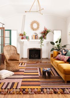 a living room filled with furniture and a fire place in the middle of the room