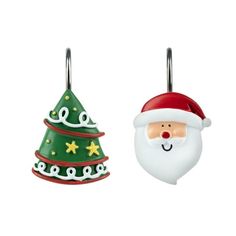 two christmas ornaments hanging from hooks on a white background, one with a santa claus face and the other with a green tree