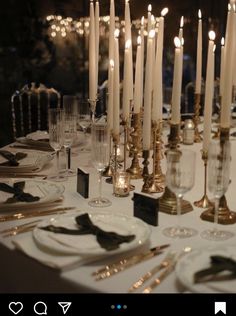 a long table is set with candles and place settings for dinner guests to enjoy the night