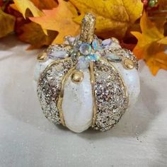 a small white pumpkin sitting on top of a table