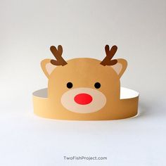 a paper reindeer head on top of a white surface