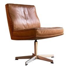 a brown leather chair sitting on top of a metal base