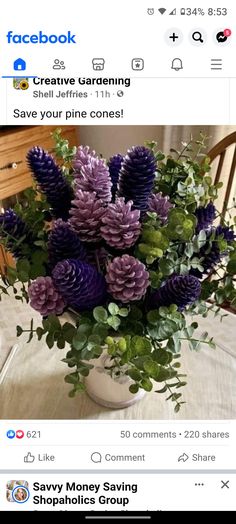 a vase filled with purple flowers on top of a table