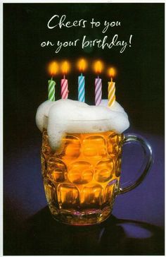 a beer mug with candles in it and the words cheers to you on your birthday