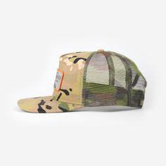 a camo hat with an orange patch on the front and green, white, and black