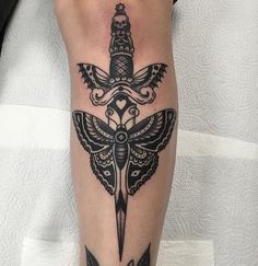 a tattoo on the leg of a person with a knife in it's hand