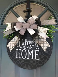 a welcome home wreath hanging on the front door