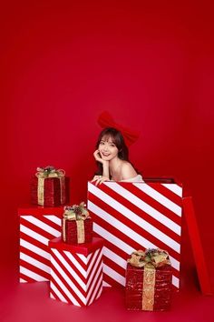 a woman sitting on top of several wrapped presents