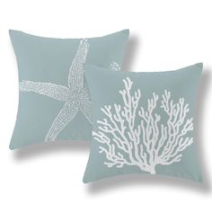 two blue pillows with white coral and starfish on them