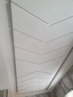 the ceiling is white and has wavy lines painted on it, along with marble flooring