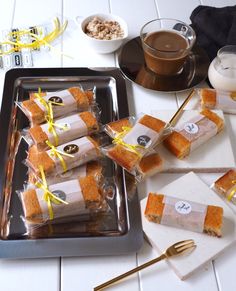 several pieces of cake sitting on top of a pan next to some forks and spoons