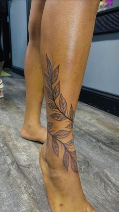 a woman's legs with leaves on them