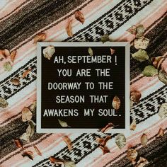 a black and white sign with leaves on it that says ah, september you are the doorway to the season that awakes my soul