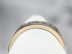 This 18 karat white gold diamond band has a classic design and shape, low domed profile, and simple row of channel-set diamonds! The diamonds are round cuts, which give the ring a lovely sparkle, capped off on each end by gleaming white gold. Metal: 18K White Gold Gem: 12 Diamonds totaling .85 Carats, H in Color, VS in Clarity Width of Band: 4.1 mm Height off Finger: 2.1 mm Ring Size: 6.50 Marks: "18KT" Stamped on the inside band Classic Formal Bands With Tension Setting, Classic Eternity Band With Channel Setting For Formal Occasions, Classic Channel Set Eternity Band For Formal Occasions, Classic Channel Set Round Band Rings, Formal Baguette Cut Eternity Band With Channel Set, Fine Jewelry Channel Set Bands For Formal Occasions, Timeless Channel Set Bands For Formal Occasions, Formal Baguette Cut Channel Set Eternity Band, Classic Diamond Ring With Channel Set Baguette Cut