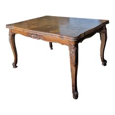 an old wooden table with ornate carvings on the top and legs, against a white background