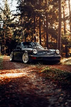 a black sports car parked in the woods