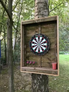 a dart board mounted to the side of a tree