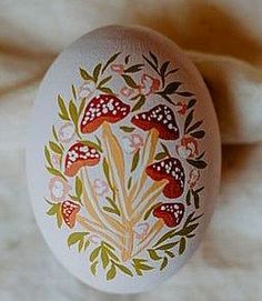 an egg decorated with flowers and leaves