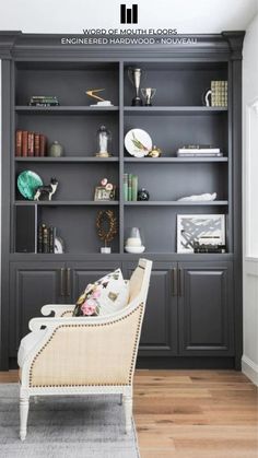 a living room filled with furniture and a flat screen tv on top of a book shelf