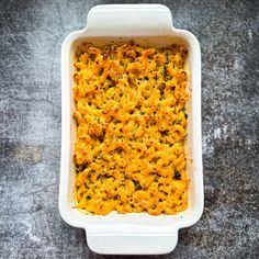 a casserole dish with cheese and broccoli in it on a table