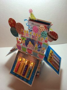 an open birthday card box with candles in it