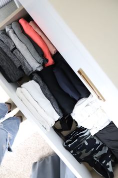 an open drawer with clothes on it