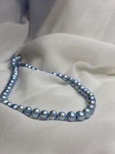 The soft, iridescent sheen of this nature freshwater pearls gives the necklace an elegant and timeless appeal, perfect for adding a touch of sophistication to any outfit.  Light blue pearls are often associated with tranquility, calmness, and communication.  Wearing this necklace can evoke a sense of peace and clarity, making it an ideal choice for occasions where you want to feel composed and centered. This versatile piece can be worn in various ways. It can complement a classic, formal outfit, Light Blue Pearl Necklace, Blue Pearl Necklace, Aesthetic Natural, Rosé Summer, Light Blue Roses, Blue Pearls, Natural Pearl Necklace, Simple Blouse, Natural Pearl