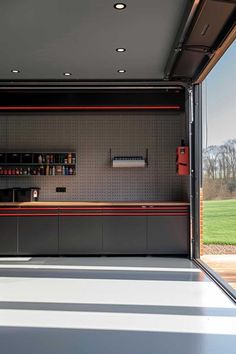 the inside of a garage with an open door and shelving unit on the wall