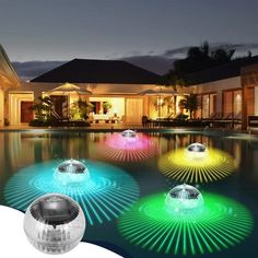 colorful lights that look like they are floating in the water next to a swimming pool