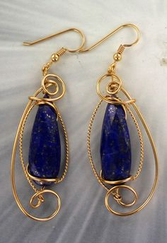 "THE BEAUTY OF Lapis Lazuli Amazing 2 28x10 MM Lapis Lazuli Stones Set in a new handcrafted 14kt rolled gold EARRING settings ---- a custom design! 28x10 mm oval shaped Stones with high detail which cannot be seen in the photograph. The Gemstones -- Intricate detail that you can see and notice Length of earrings ----- 1 3/4 INCH LONG (without hooks) Very delicate and intricate in appearance and will get you noticed! One of a kind handcrafted piece of jewelry that anyone will look good on you Abs Handmade Lapis Lazuli Yellow Gold Jewelry, Elegant Wire Wrapped Lapis Lazuli Earrings, Handmade Gold Lapis Lazuli Earrings, Bohemian Lapis Lazuli Wire Wrapped Jewelry, Gold Lapis Lazuli Gemstone Earrings, Sculpted Jewelry, Lapis Jewelry, Lapis Lazuli Gemstone, Wrap Earrings