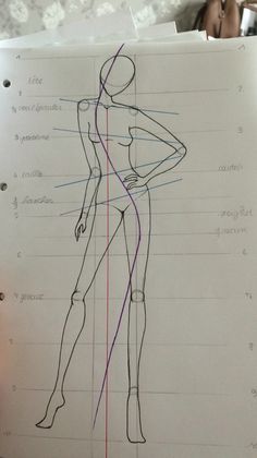 a drawing of a woman's body with lines drawn on the paper next to it