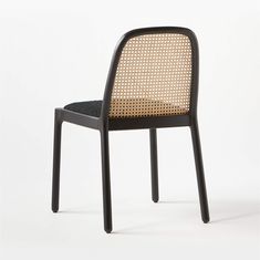 a chair with a black frame and woven seat pad on the back, in front of a white background