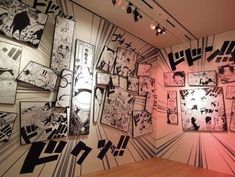 an art gallery with many black and white drawings on the walls, including one large piece of artwork