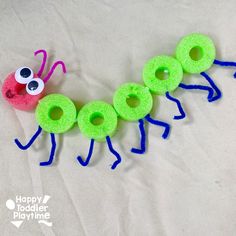 the very cute caterpillar craft is made with yarn and felt eyes are on top of each other