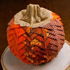 a decorative pumpkin sitting on top of a white plate