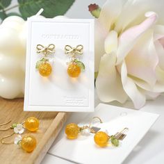 Embrace the radiance of this golden shiny orange fruit earrings and let it be the finishing touch that elevates your confidence and charm. 🍊Premium Material: handmade high quality with Czech glass oranges, acrylic flowers, acrylic leaves, and 14K gold plated/925 sterling silver-plated ear hooks (hypoallergenic).  🌺Size: the hook style is about 0.6" wide and 1.35" long | the stud style is about 0.6" wide and 1" long 💌Handmade: Each item is made to order, which gives our pieces a unique meaning Yellow Fruit Design Earrings For Gift, Yellow Fruit Design Earrings Gift, Yellow Fruit Design Earrings As Gift, Orange Drop Earrings For Anniversary, Elegant Apricot Earrings For Gift, Elegant Orange Earrings For Gift, Apricot Drop Earrings For Gifts, Fruit Design Drop Earrings As Gift, Fruit Design Drop Earrings For Gift