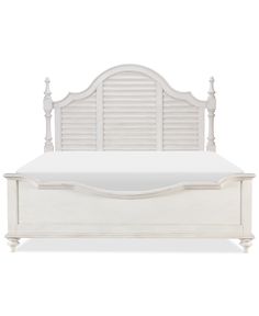 a white bed with shutters on the headboard and foot board