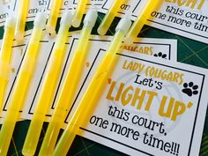 four yellow toothbrushes sitting next to each other on top of a green table